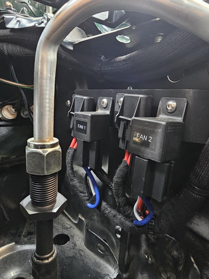 Labeled fan 1 and fan 2 relays on a custom mounting plate with loomed wiring