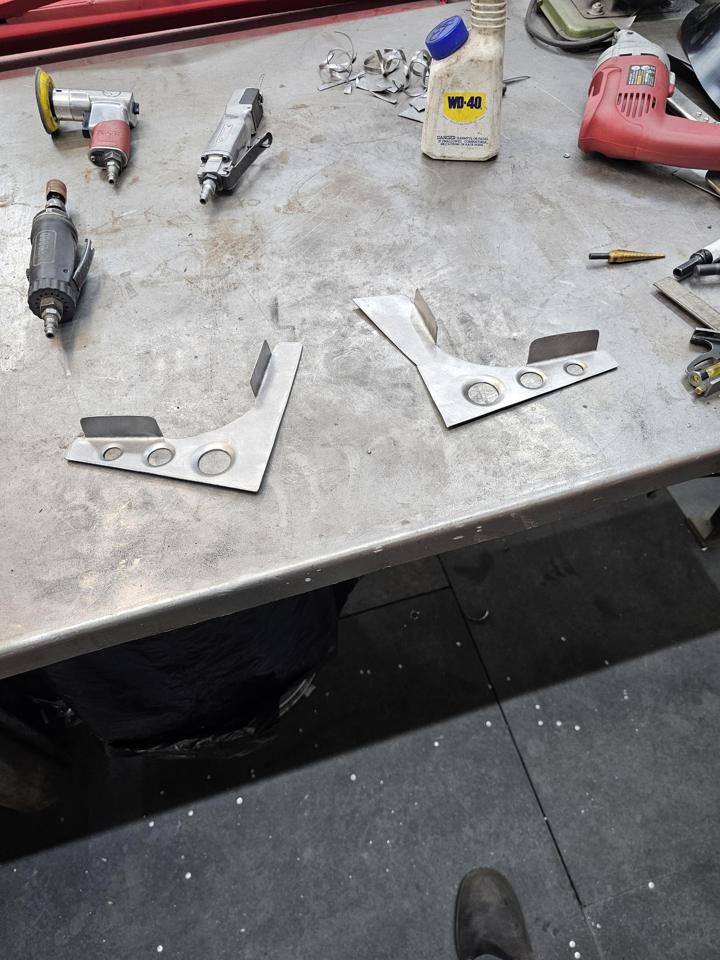 Pair of custom gussets with dimple-die holes and formed flanges