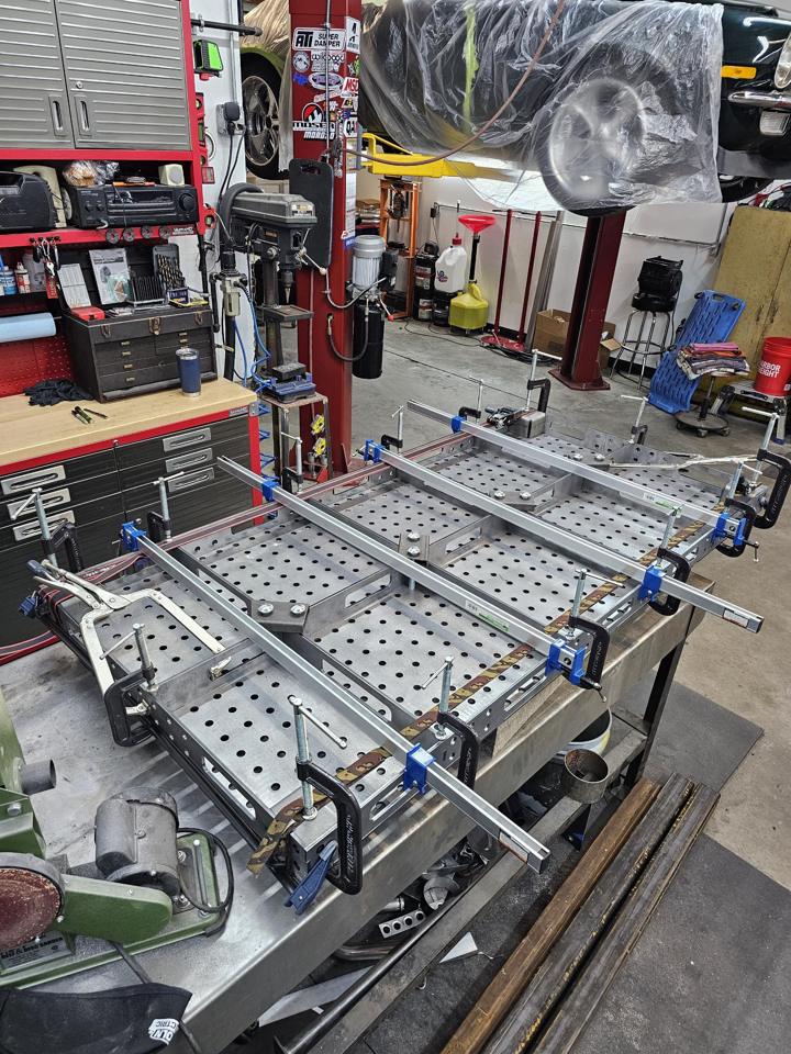 Fabricated fixture table clamped square and flat on the welding bench for final welding