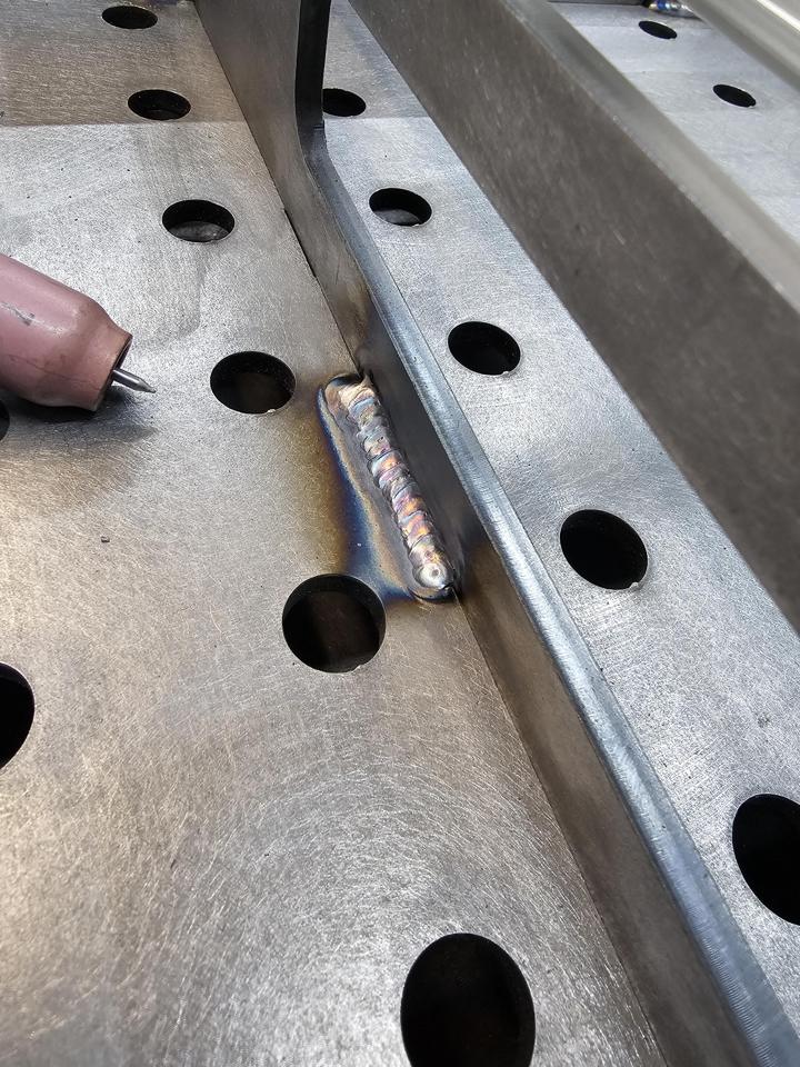 TIG fillet weld on steel with the torch alongside