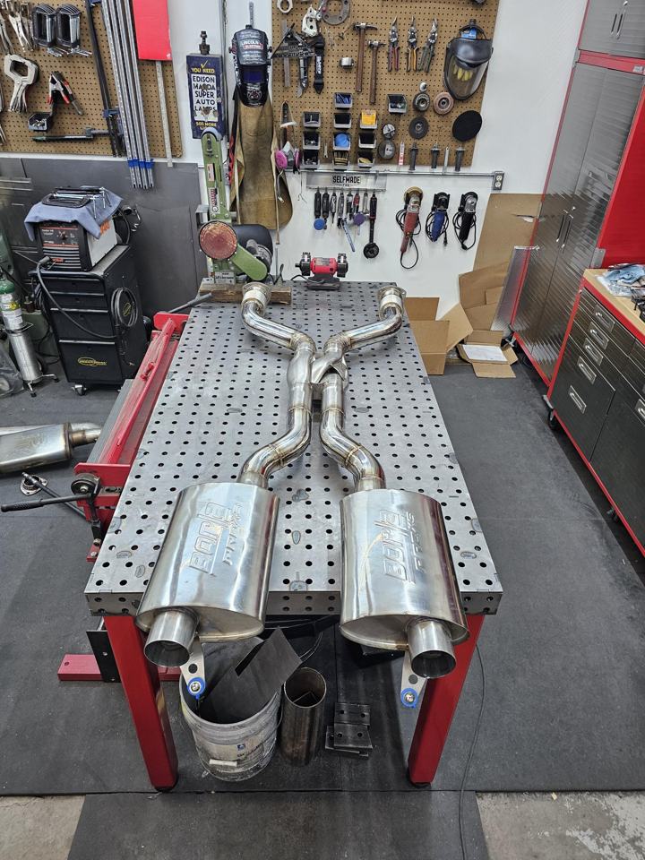 Stainless dual exhaust with X-pipe, V-band flanges and Borla mufflers on the shop welding table