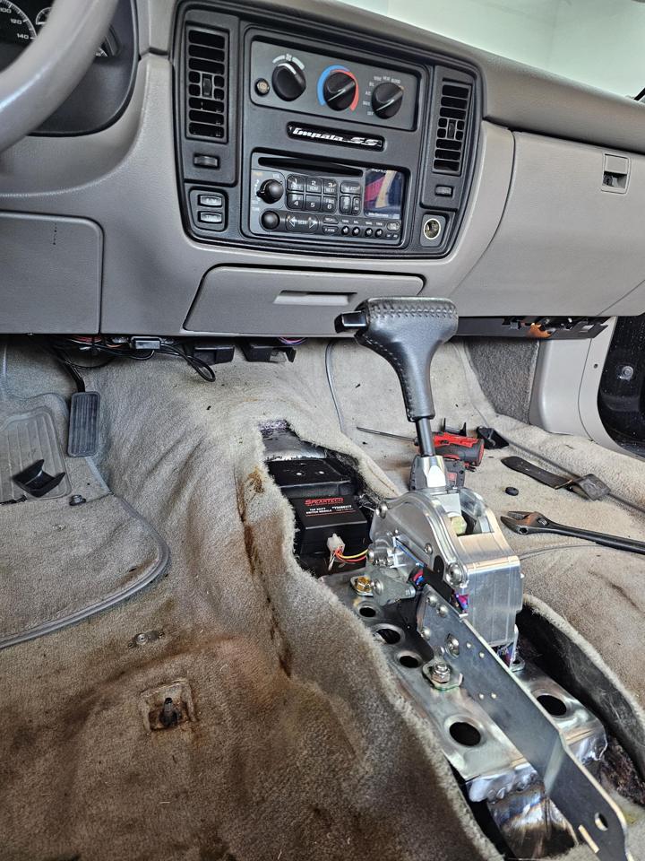 Aftermarket shifter and Speartech tap-shift module installed in an Impala SS